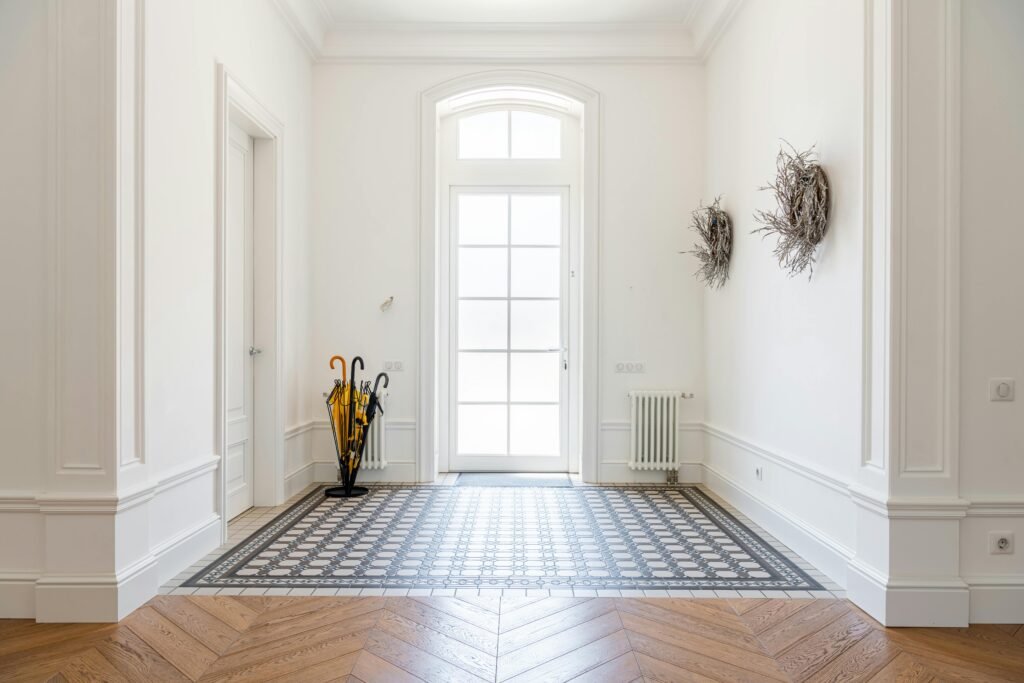 pexels-photo-8143680-8143680 Bright foyer showcasing sophisticated interior design with parquet flooring and decor elements.